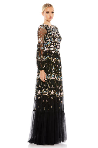 Side three-quarter view of the black gown showing the gathered sleeve cuff and tiered hem by Mac Duggal at Mrs. G