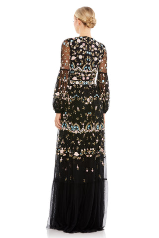 Back view of the black embroidered gown with semi-sheer blouson sleeves and floral mesh bodice by Mac Duggal at Mrs. G