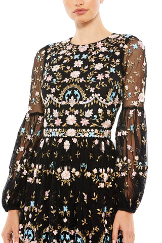 Zoomed-in close-up of the pink and blue floral embroidery on the high neckline and sleeves by Mac Duggal at Mrs. G