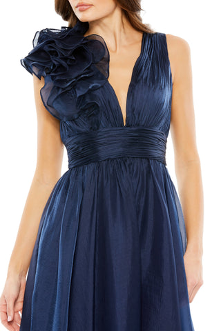 Close-up of the ruffled shoulder rosette and deep V-neckline on the midnight chiffon dress by Mac Duggal at Mrs. G
