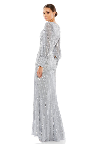 Back view of the silver sequin gown showing the long bishop sleeves and floor-length skirt by Mac Duggal at Mrs. G