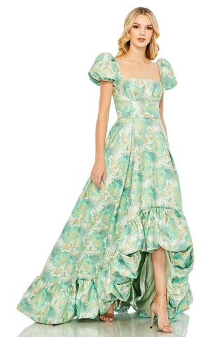 Full-length front view of the spring green floral brocade dress with puff sleeves and a high-low ruffle hem by Mac Duggal at Mrs. G
