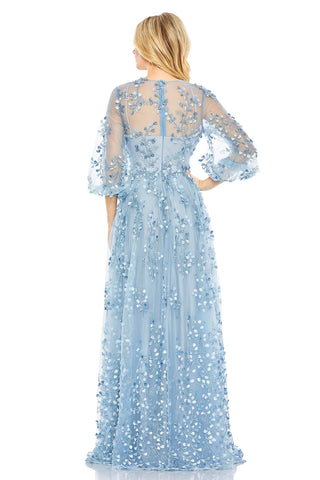 Back view of the blue embroidered gown showing the sheer illusion upper back and gathered sleeves by Mac Duggal at Mrs. G