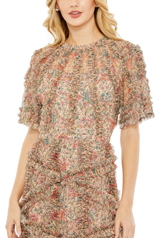 Close-up of the ruffled neckline, flutter sleeve and floral print on the beige midi dress by Mac Duggal at Mrs. G