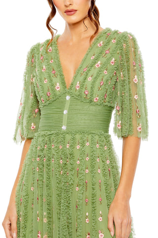 Close-up of the ruffle-trimmed V-neck, three jeweled buttons and ruched empire waist on the moss green gown by Mac Duggal at Mrs. G
