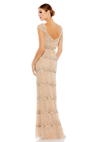 Three-quarter back view of the beige beaded gown showing the scoop back and scalloped bead tiers by Mac Duggal at Mrs. G
