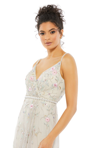 Waist-up view of the beige embroidered gown with pearl-trimmed straps and beaded waist by Mac Duggal at Mrs. G