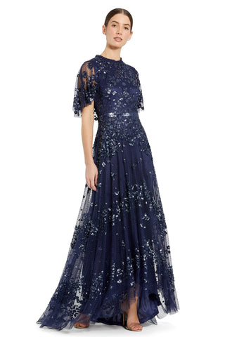 Front view of the navy sequin gown with flutter sleeves, sequin belt and high-low hem by Mac Duggal at Mrs. G