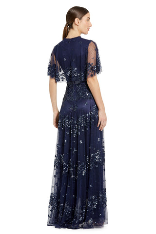 Back view of the navy sequin gown with sheer flutter sleeves and a back zipper by Mac Duggal at Mrs. G