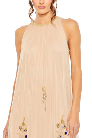 Zoomed-in close-up of the gold beaded collar and floral beadwork on the beige trapeze gown by Mac Duggal at Mrs. G