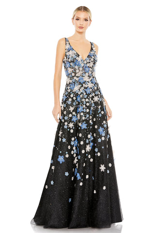 Full-length front view of the black A-line gown with blue and white appliqué flowers and V-neck by Mac Duggal at Mrs. G