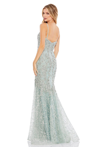 Back view of the mint trumpet gown showing the scooped back and silver sequin vine skirt by Mac Duggal at Mrs. G