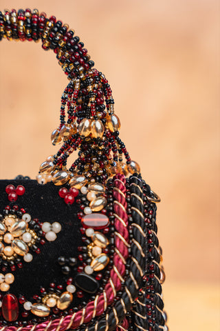 Black empress charm flap bag, close-up detail, by Nayaab by Sonia at Mrs. G
