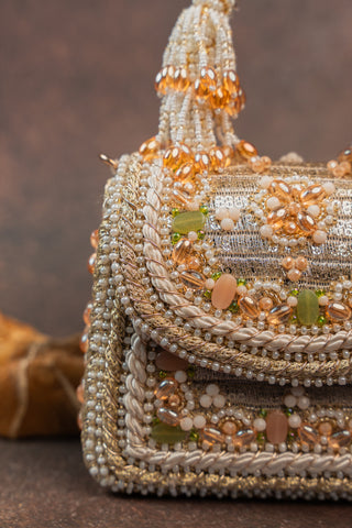Gold empress charm flap bag, close-up detail, by Nayaab by Sonia at Mrs. G