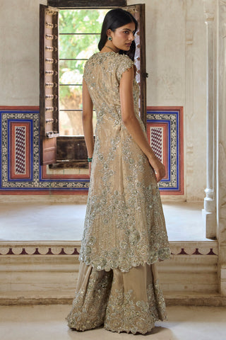 Back view of beige champagne jacket with scalloped floral hem over flared pants by Osaa by Adarsh at Mrs. G