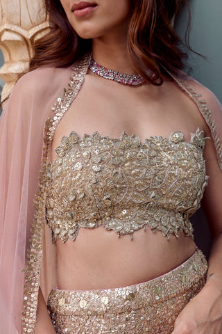 Close-up of camellia pink strapless bustier with scalloped edge and raised gold floral appliqué by Osaa by Adarsh at Mrs. G