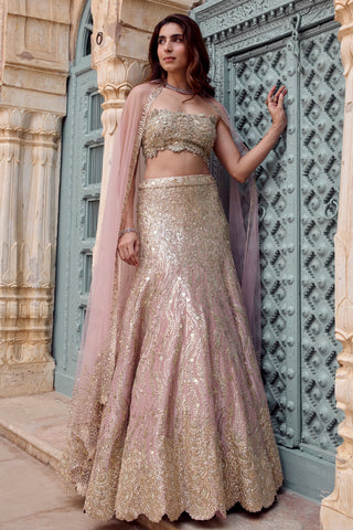 Three-quarter view of camellia pink sequin lehenga with scalloped hem and tulle dupatta over the shoulders by Osaa by Adarsh at Mrs. G