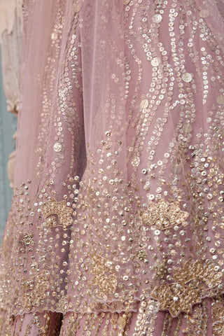 Close-up of camellia pink tulle skirt with wavy sequin lines and gold flower motifs at the hem by Osaa by Adarsh at Mrs. G