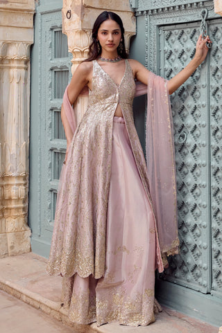 Side view of camellia pink jacket open at the waist over garara with scalloped gold hem by Osaa by Adarsh at Mrs. G