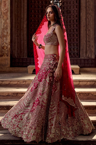 Three-quarter view of dark fuchsia lehenga in motion with veil, showing the full flare by Osaa by Adarsh at Mrs. G