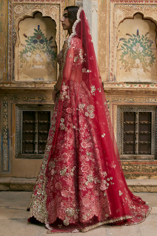 Side view of deep berry bridal lehenga with the red tulle dupatta trailing behind by Osaa by Adarsh at Mrs. G