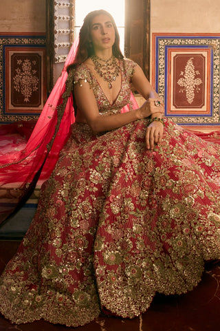 Seated view of deep berry lehenga skirt spread out with the red tulle dupatta and scalloped hem by Osaa by Adarsh at Mrs. G