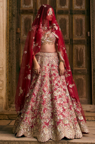 Deep berry bridal lehenga worn with the red tulle over the head, full-length front view by Osaa by Adarsh at Mrs. G