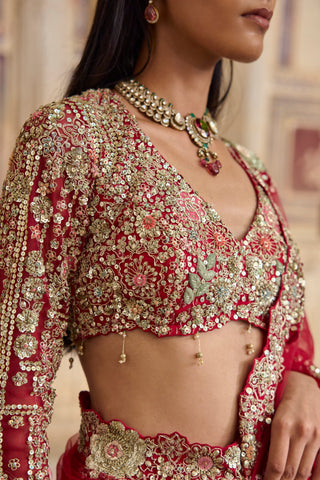 Close-up of the deep berry blouse with V-neckline, sequin florals and gold tassel drops at the hem by Osaa by Adarsh at Mrs. G