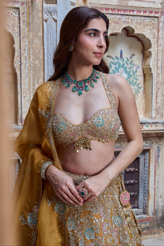 Waist-up view of honey orange halter blouse with scalloped edge and organza dupatta by Osaa by Adarsh at Mrs. G