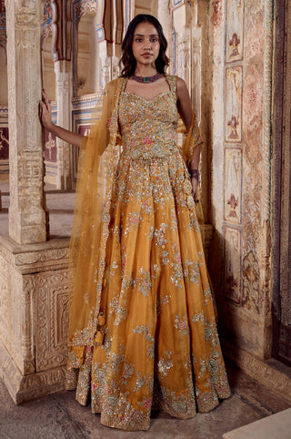 Full-length view of honey orange organza lehenga with zardozi flower sprays and draped dupatta by Osaa by Adarsh at Mrs. G