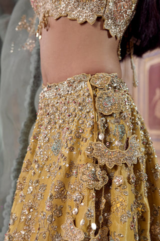 Close-up of the maize yellow lehenga waist with raised floral latkans and zardozi skirt embroidery by Osaa by Adarsh at Mrs. G