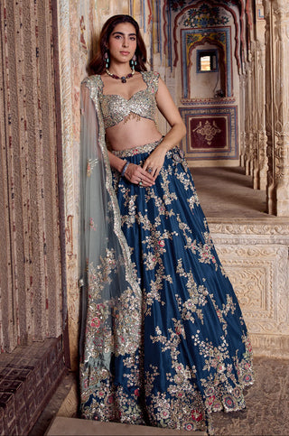 Three-quarter view of midnight blue flared lehenga with scattered zardozi flower sprays by Osaa by Adarsh at Mrs. G