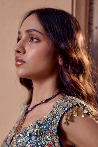 Close-up of midnight blue jacket shoulder with gold sequin disc tassels and zardozi by Osaa by Adarsh at Mrs. G