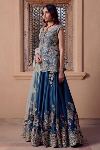 Three-quarter view of midnight blue flared lehenga with zardozi flower hem border and hip tassels by Osaa by Adarsh at Mrs. G