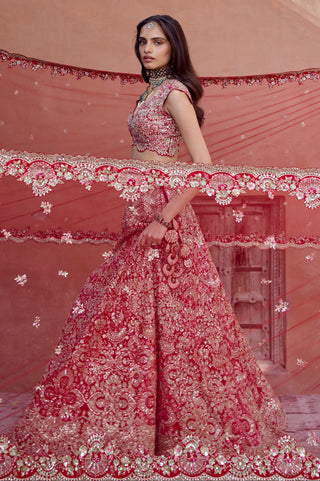 Side view of rosewood red lehenga with the sheer veil and scalloped dupatta border flowing out by Osaa by Adarsh at Mrs. G