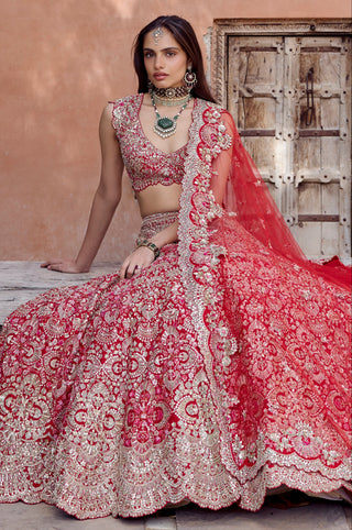 Seated view of rosewood red bridal lehenga with the net dupatta spread across the skirt by Osaa by Adarsh at Mrs. G