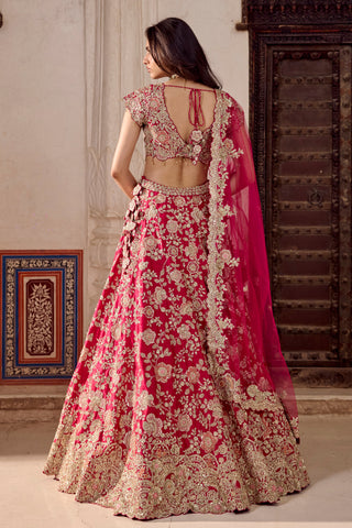 Back view of ruby pink bridal lehenga with tie-up back blouse and scalloped paisley hem border by Osaa by Adarsh at Mrs. G