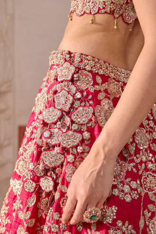 Zoomed-in close-up of tassel latkan of embroidered flowers on the ruby pink lehenga waistband by Osaa by Adarsh at Mrs. G