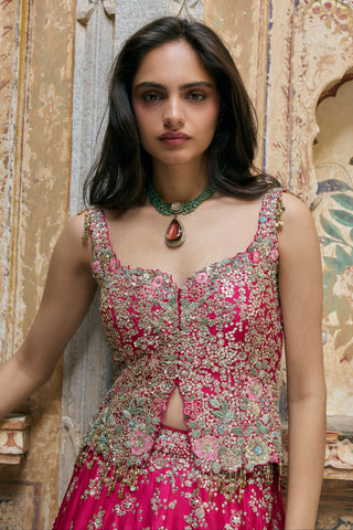 Close-up of ruby pink peplum top with sweetheart neckline, front slit and beaded tassel drops by Osaa by Adarsh at Mrs. G