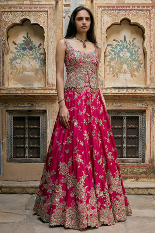Full-length front view of ruby pink lehenga skirt with zardozi sprays and scalloped hem by Osaa by Adarsh at Mrs. G