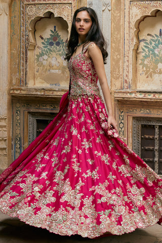 Twirling view of ruby pink lehenga showing full skirt and embroidered scalloped hem by Osaa by Adarsh at Mrs. G