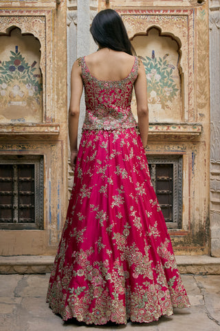 Back view of ruby pink peplum top with scoop back and full zardozi lehenga by Osaa by Adarsh at Mrs. G