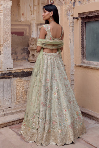 Back view of sage lehenga set with scooped-back blouse and floral skirt with zardozi hem by Osaa by Adarsh at Mrs. G