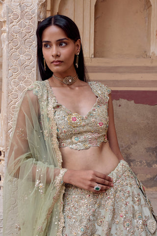 Waist-up view of sage blouse with scalloped neckline, leaf-shaped hangings and net dupatta by Osaa by Adarsh at Mrs. G