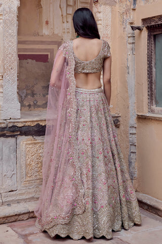 Back view of skin rose lehenga with open scoop back blouse and dupatta draped down the skirt by Osaa by Adarsh at Mrs. G