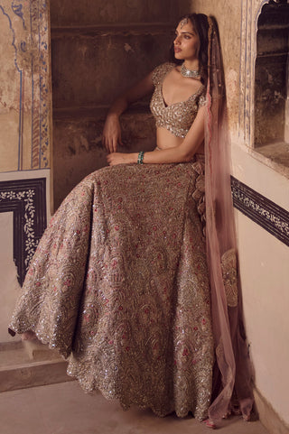 Seated view of skin rose bridal lehenga skirt spread out with the dupatta and scalloped hem by Osaa by Adarsh at Mrs. G