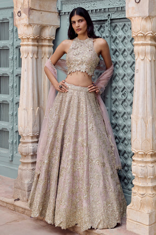 Front view of tan high-neck zardozi lehenga set with halter blouse and tulle dupatta by Osaa by Adarsh at Mrs. G