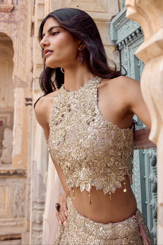Close-up of tan halter blouse with raised floral appliqué and gold charm drops by Osaa by Adarsh at Mrs. G