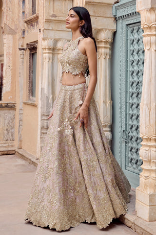 Side view of tan lehenga with scalloped hem and flower tassel waist tie by Osaa by Adarsh at Mrs. G
