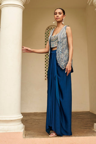 Three-quarter view of jade blue open jacket, bustier and draped skirt by Osaa by Adarsh at Mrs. G